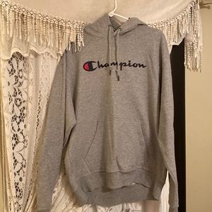 A large grey champion hoodie with hoodie and front pockets